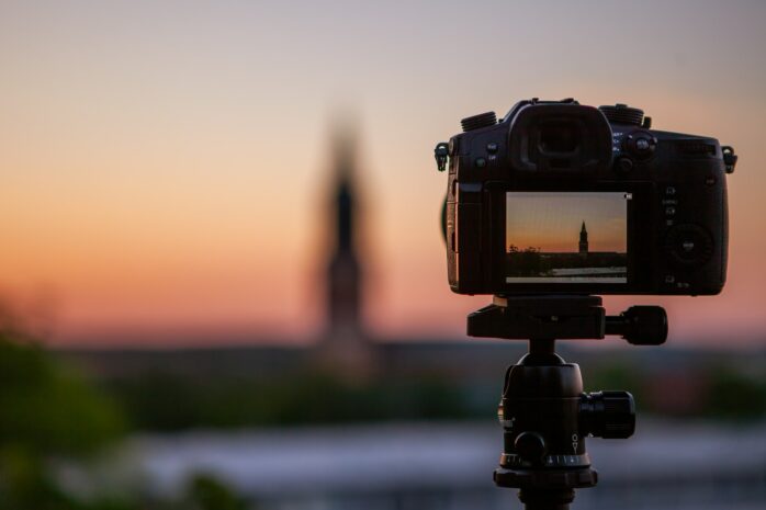 Camera on a tripod taking a picture of a sunset