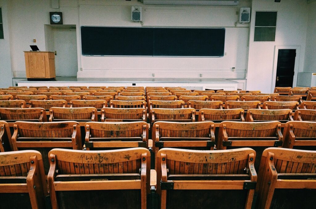 Empty room with a lot of chairs and a whiteboard